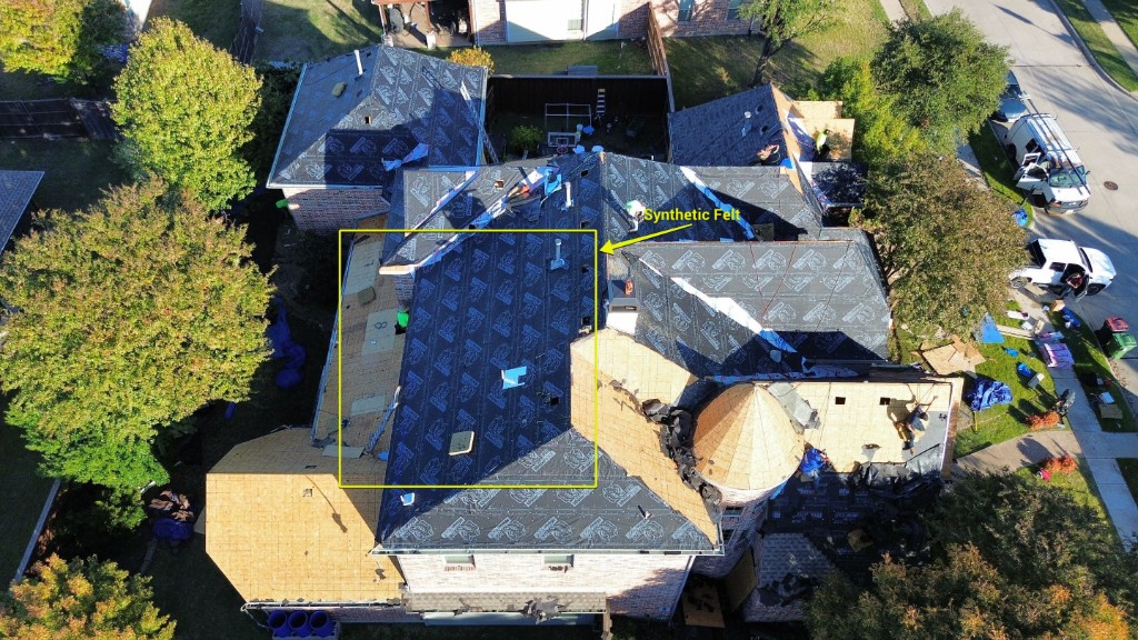 Roof crew installing synthetic felt underlayment on a complex roof in Bluff Creek Estates, Murphy, Texas