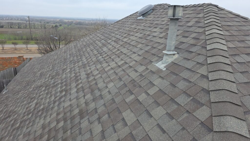 Close-up of architectural asphalt shingles on a completed Celina, Texas roof