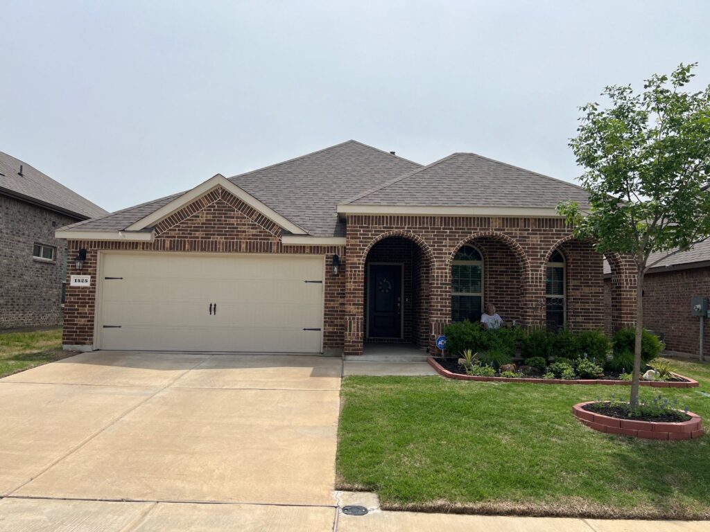 Single-story brick ranch with an arched porch and new architectural-shingle hip roof in Celina, Texas