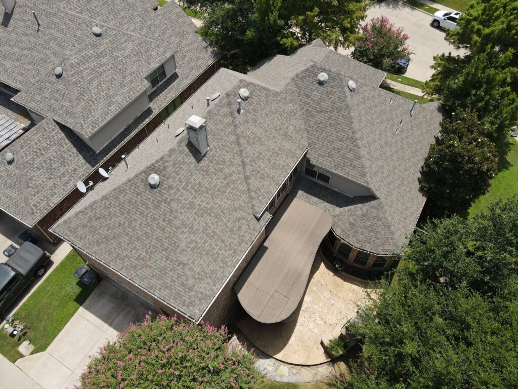 Aerial view of a completed hip-and-gable architectural shingle roof in Allen, Texas