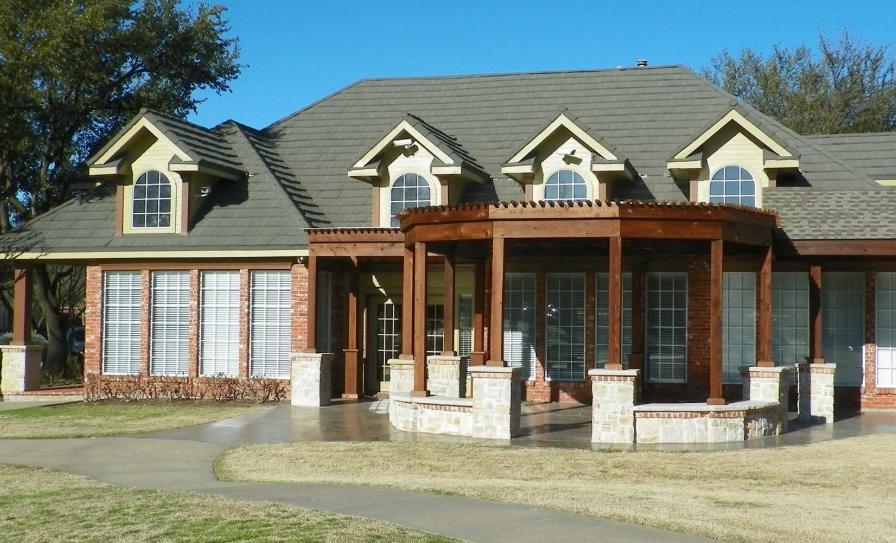 Deerfield neighborhood clubhouse with brick dormers and wood pergola in Plano, Texas