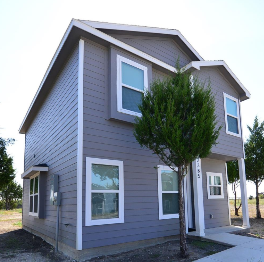 Modern two-story gray siding home with white trim in Eagle Glen, Murphy, Texas