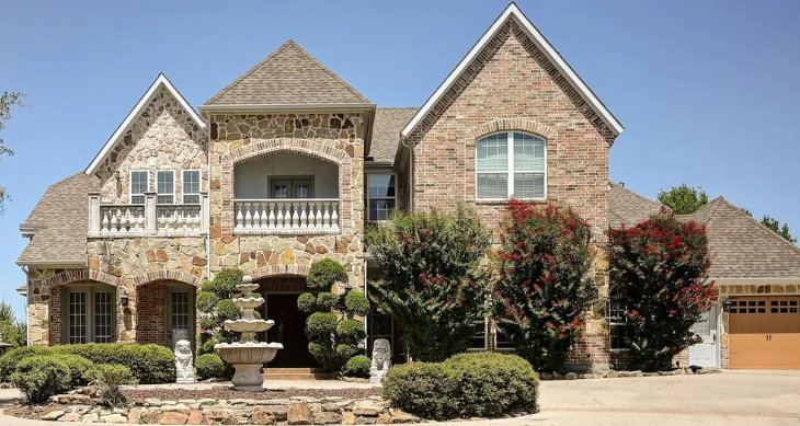 Luxury stone and brick home with fountain in Fairway Estates, Murphy, Texas