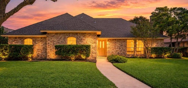 One-story limestone ranch home with hip roof and walkway in Fountain Park, Allen, Texas