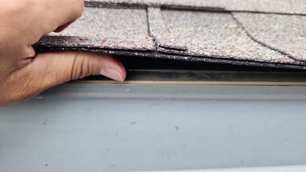 Close-up of an architectural shingle overhanging a metal drip edge on a Celina, Texas roof