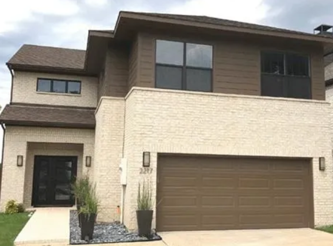 Modern cream brick and dark siding home in Maxwell Creek North, Murphy, Texas