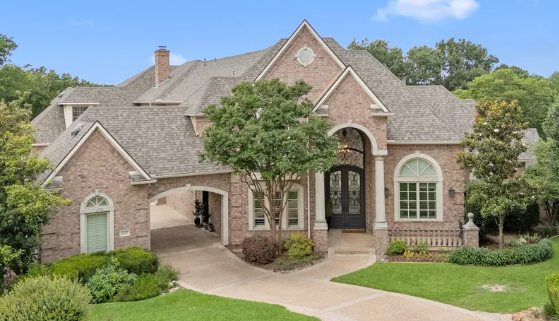 Two-story brick estate home with arched entry in Shoal Creek, Plano, Texas