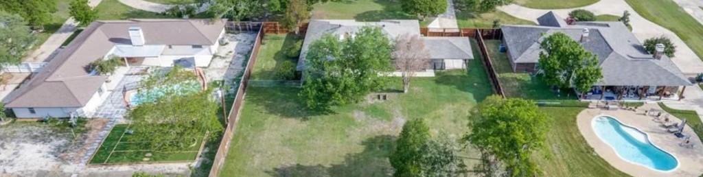Aerial view of spacious Skyline Acres ranch homes with private yards and pools in Murphy, Texas