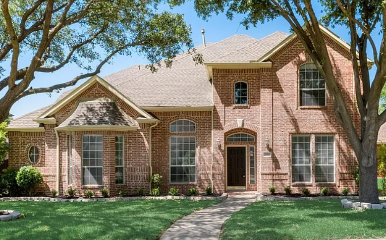 Two-story brick home with mature trees in Spring Ridge, Plano, Texas