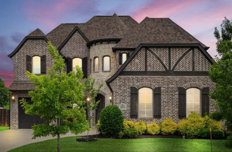Luxury brick and stone home at twilight in Stonelake Estates, Frisco, Texas