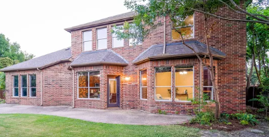 Two-story brick rear elevation with patio in Stratford Crossing, Murphy, Texas