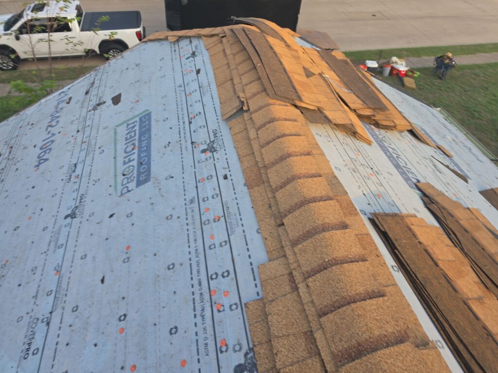 Tan architectural shingles being installed over synthetic underlayment on an Allen, Texas roof