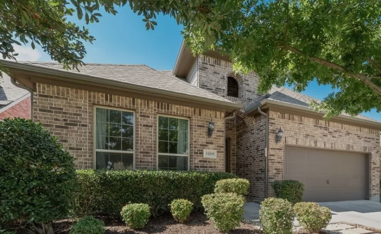 Light brown brick ranch home in The Ranch community, Murphy, Texas