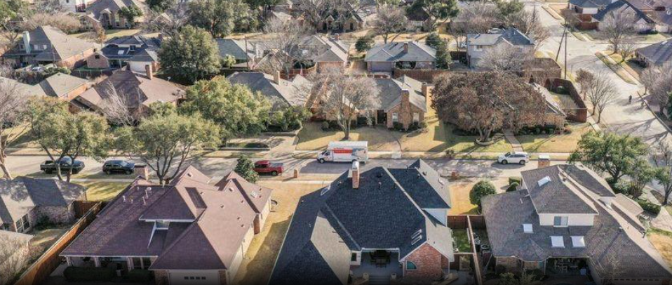 Aerial view of brick homes and streetscape in Whiffletree, Plano, Texas